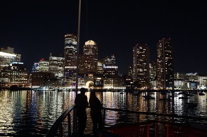 Boston Harbor Night Cruise - The harbor view of Bunker Hill Monument and USS Constitution